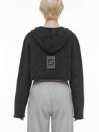 CLAiRE Vintage Washed Raw Edge Hoodie in Washed Black worn by a model, back view with back logo.