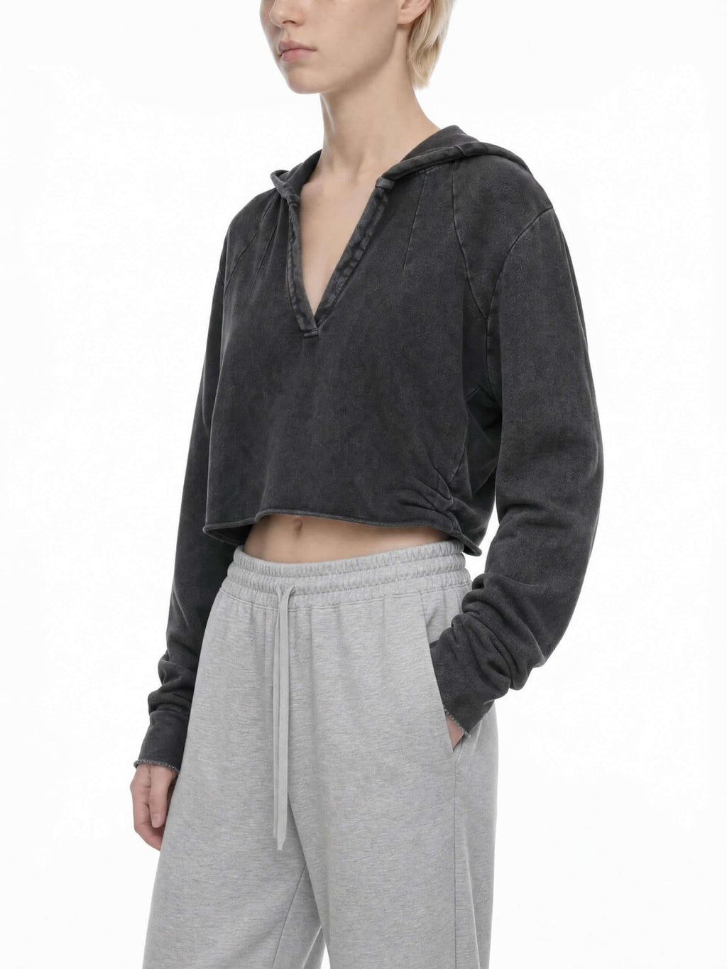 CLAiRE Vintage Washed Raw Edge Hoodie in Washed Black worn by a model, front three-quarter view.