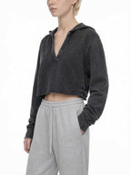 CLAiRE Vintage Washed Raw Edge Hoodie in Washed Black worn by a model, front three-quarter view.