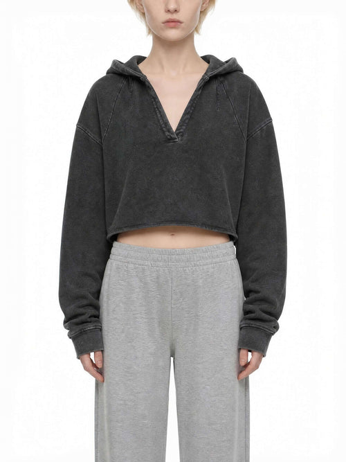 CLAiRE Vintage Washed Raw Edge Hoodie in Washed Black worn by a model, front view.