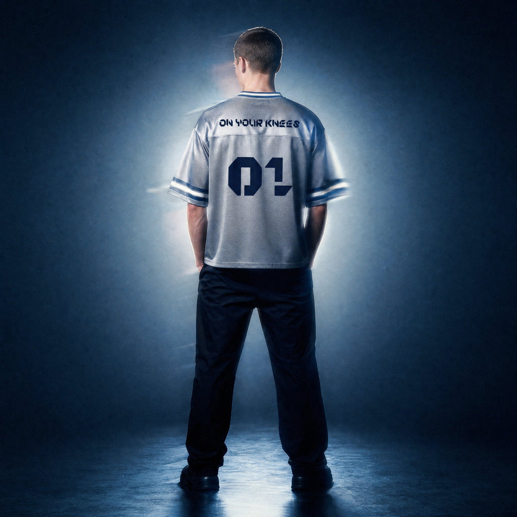 Back view of the gray boxy striped soccer jersey by Merch in Town x Guillaume Michaud, showing the ON YOUR KNEES 01 print.