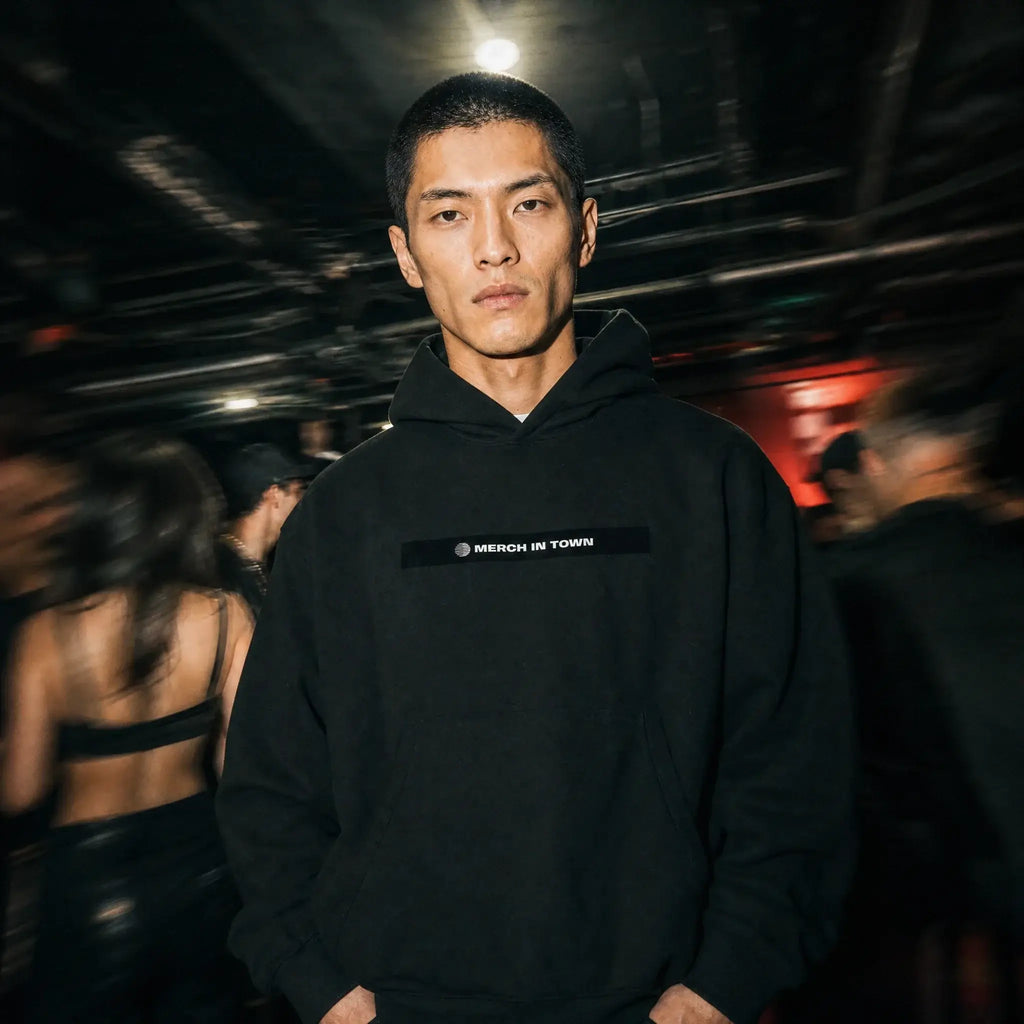 Merch in Town Essential Oversized Boxy Fit Fleece Hoodie in Black, front lifestyle shot