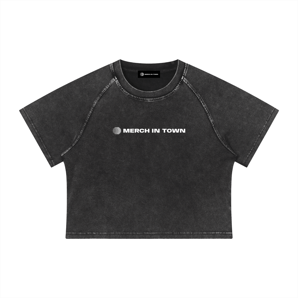 Merch in Town Women's Mineral Wash Raglan Crop T-Shirt in Black on a white background, front view.