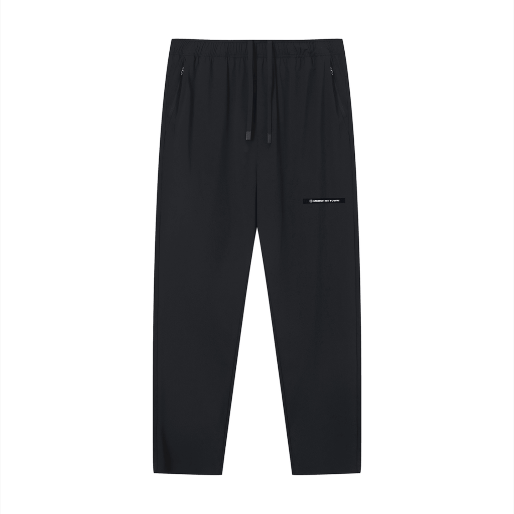 Merch in Town Lightweight Tapered Track Pants in Black on a white background, front view.