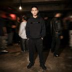 Merch in Town Lightweight Tapered Track Pants in Black, full-length lifestyle shot