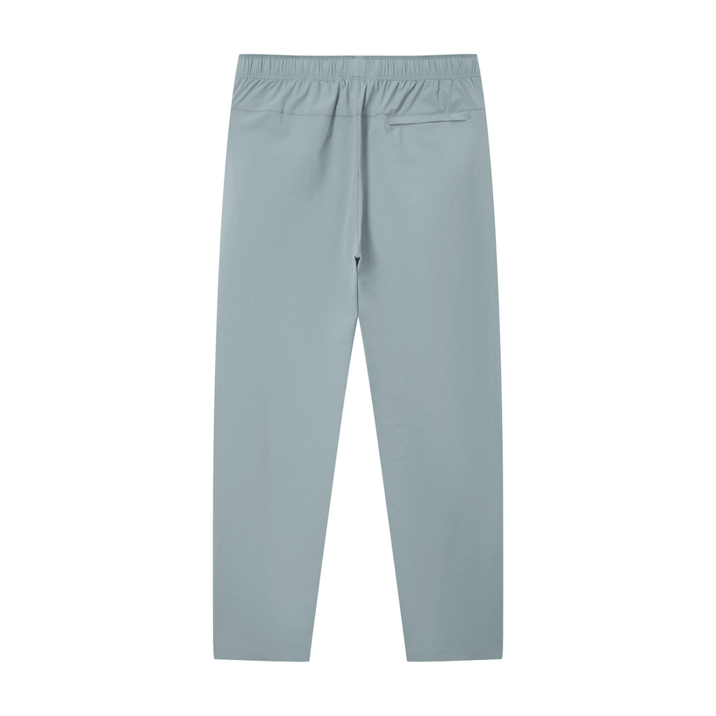 Merch in Town Lightweight Tapered Track Pants in Gray Blue on a white background, back view.