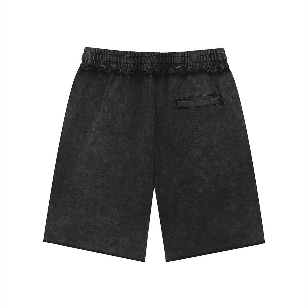 Salon Daomé black mineral wash raw edge shorts on a white background, back view.