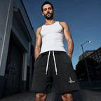 Salon Daomé black mineral wash raw edge shorts worn with a white tank on an evening street.