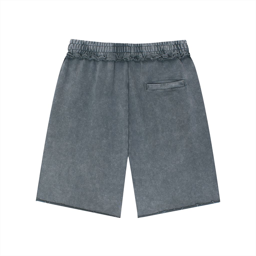Salon Daomé medium gray mineral wash raw edge shorts on a white background, back view.