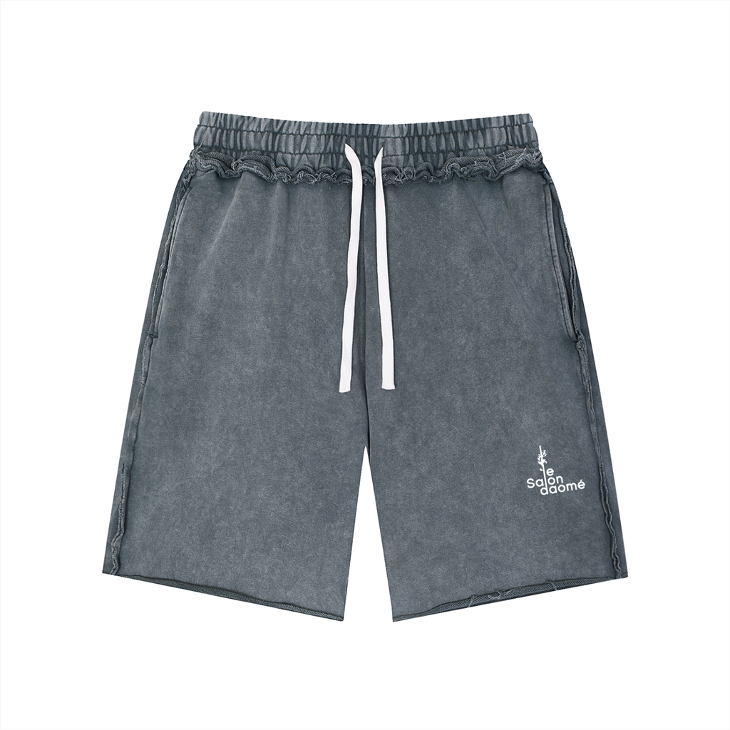 Salon Daomé medium gray mineral wash raw edge shorts on a white background, front view.