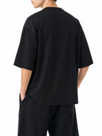 Teeto Oversized Drop Shoulder T-Shirt in Black worn by a model, back view.