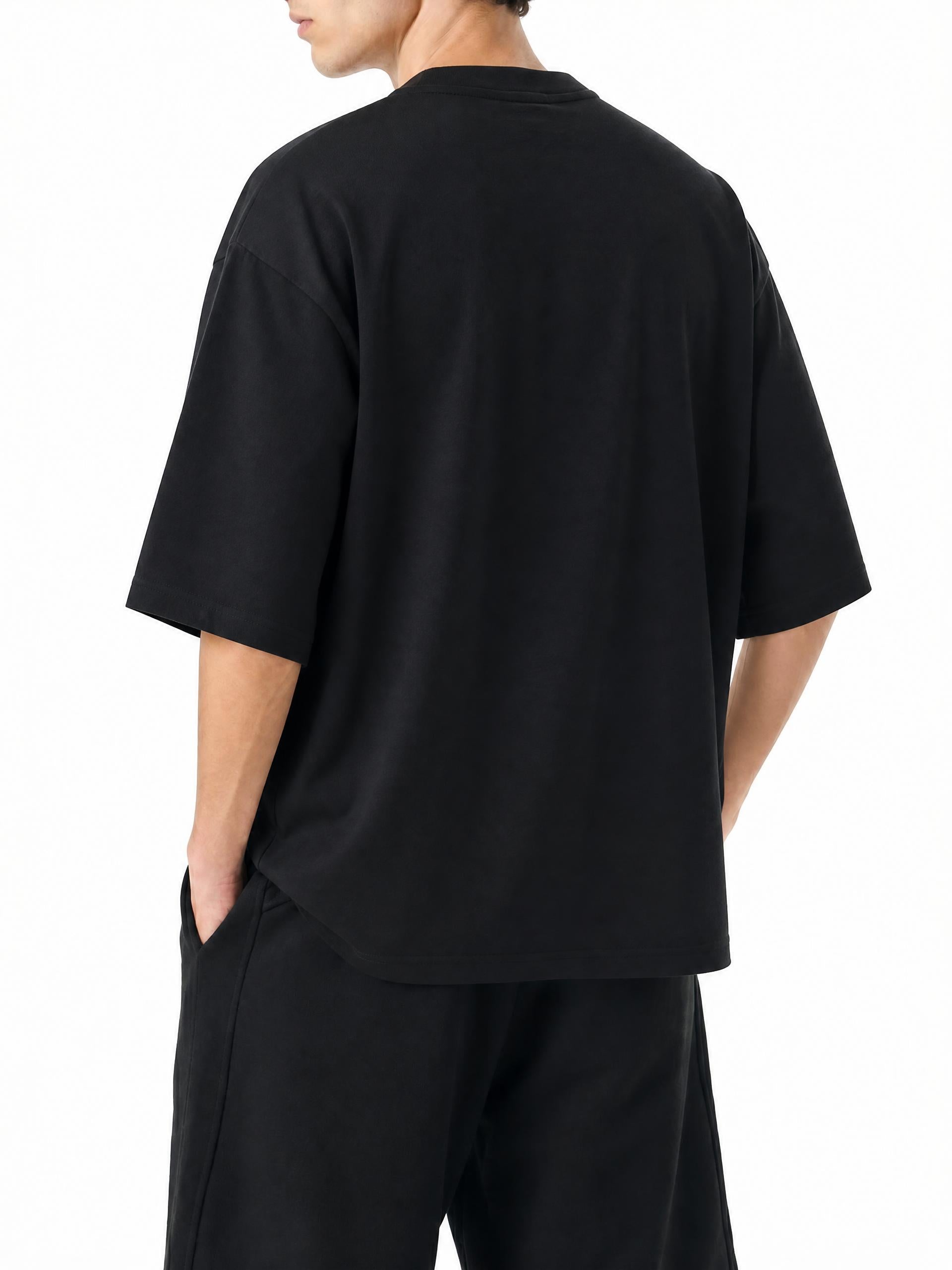Teeto Oversized Drop Shoulder T-Shirt in Black worn by a model, back view.
