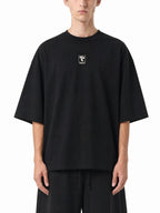 Teeto Oversized Drop Shoulder T-Shirt in Black worn by a model, front view.
