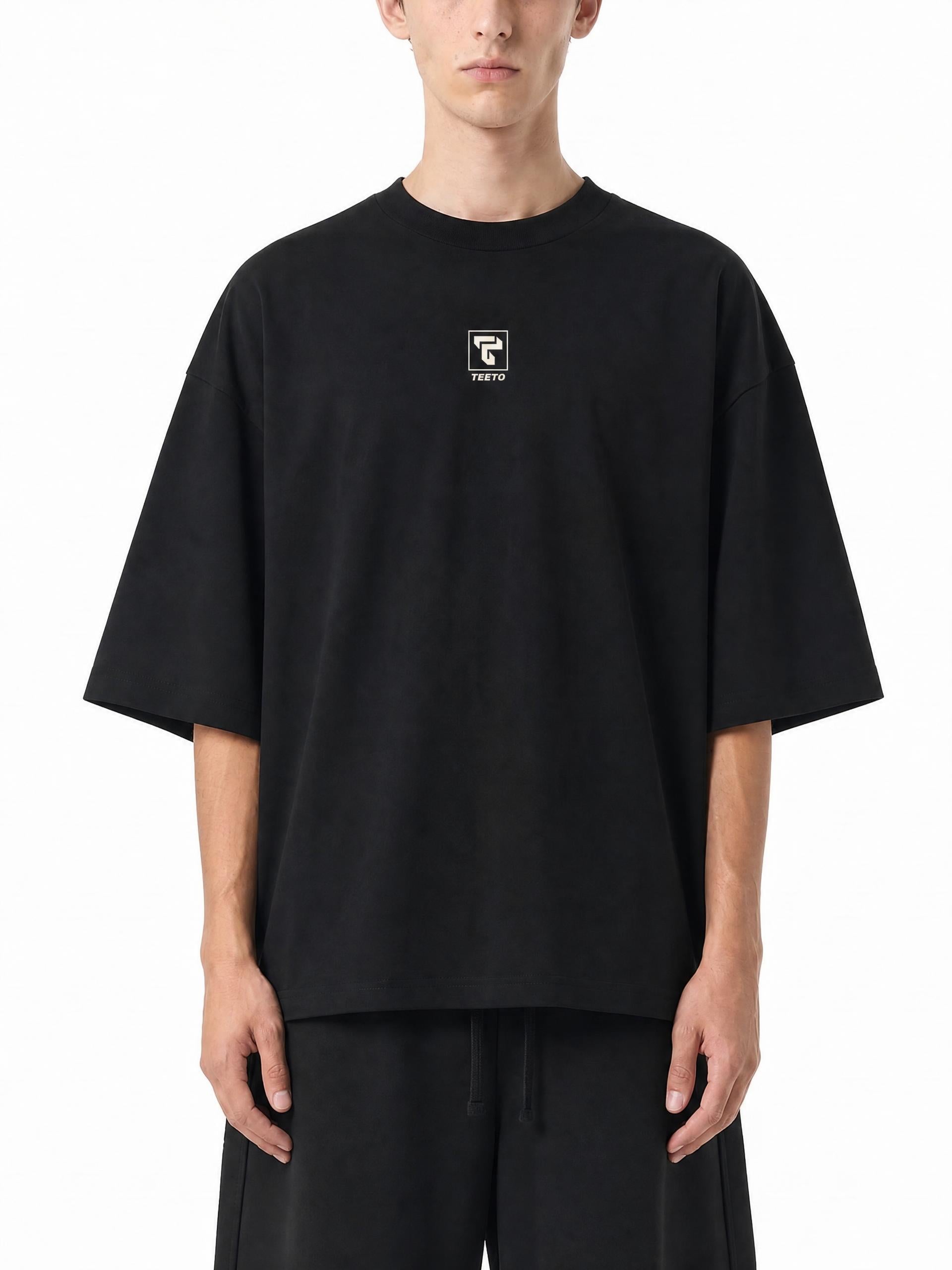 Teeto Oversized Drop Shoulder T-Shirt in Black worn by a model, front view.
