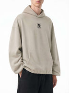 Teeto Boxy Gather-Hem Hoodie in Khaki, front three-quarter view.