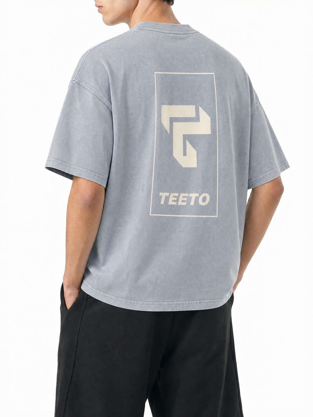 Teeto Mineral Wash Boxy Cotton T-Shirt in Light Gray worn by a model, back view with TEETO back logo.