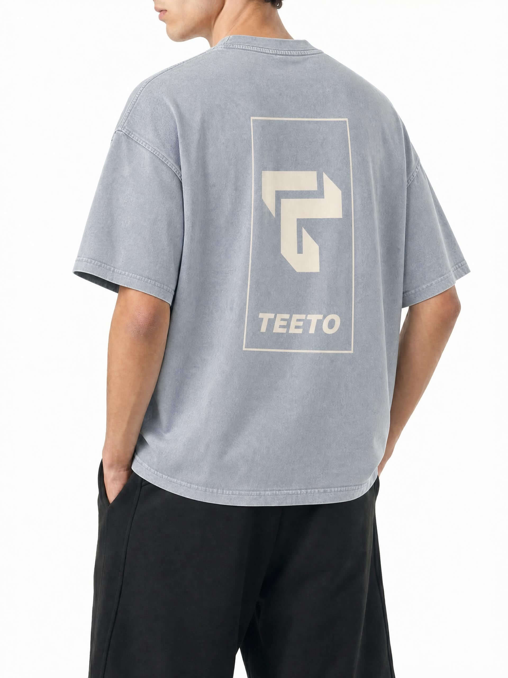Teeto Mineral Wash Boxy Cotton T-Shirt in Light Gray worn by a model, back view with TEETO back logo.