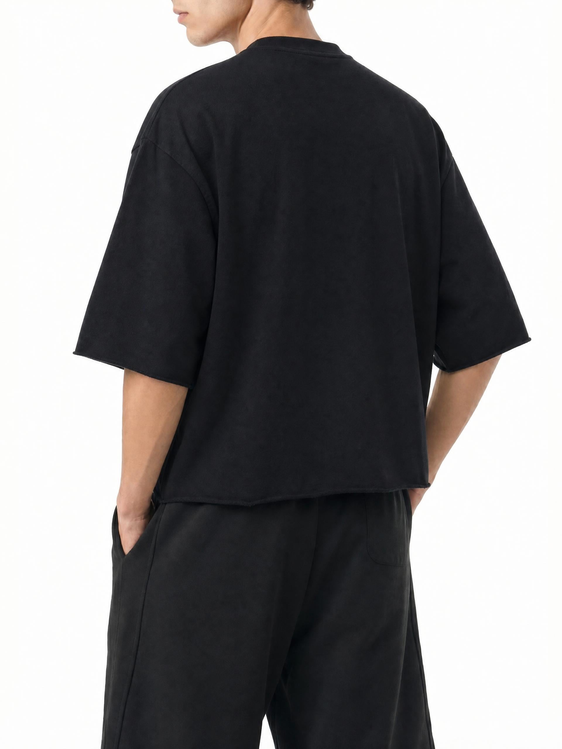 Teeto Mineral Wash Raw Hem Boxy T-Shirt in Black worn by a model, back view.