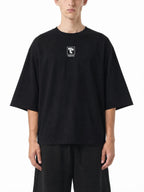 Teeto Mineral Wash Raw Hem Boxy T-Shirt in Black worn by a model, front view.