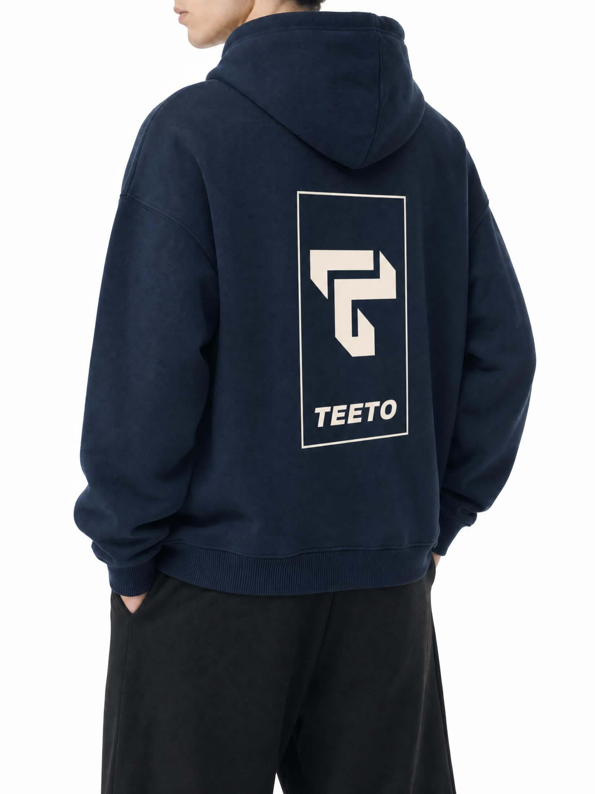 Teeto Oversize Fleeced Hoodie in Navy Blue worn by a model, back view with TEETO back logo.