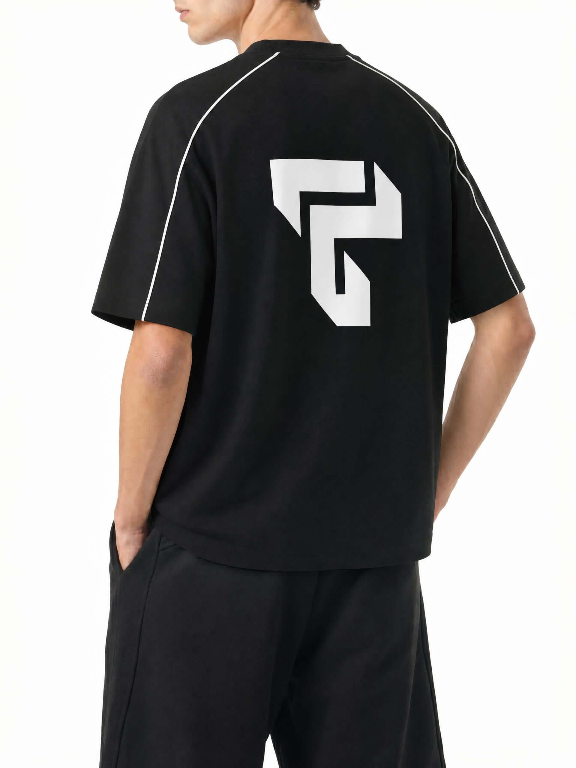 Teeto Heavyweight Boxy Piping T-Shirt in Black worn by a model, back view with TEETO back logo.