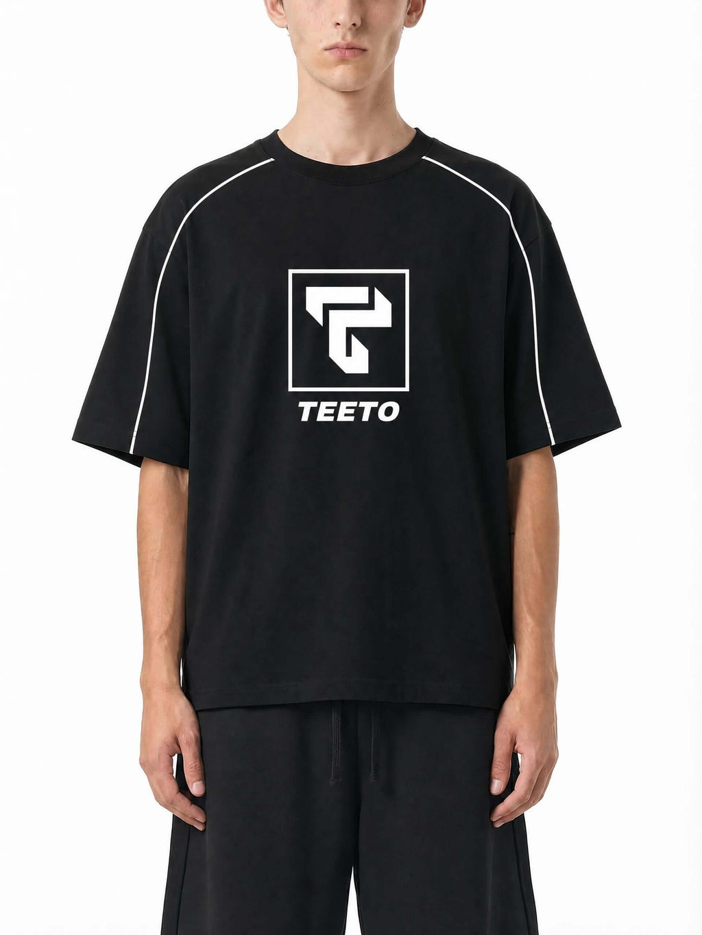 Teeto Heavyweight Boxy Piping T-Shirt in Black worn by a model, front view.