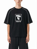 Teeto Heavyweight Boxy Piping T-Shirt in Black worn by a model, front view.