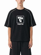 Teeto Heavyweight Boxy Piping T-Shirt in Black worn by a model, front view.