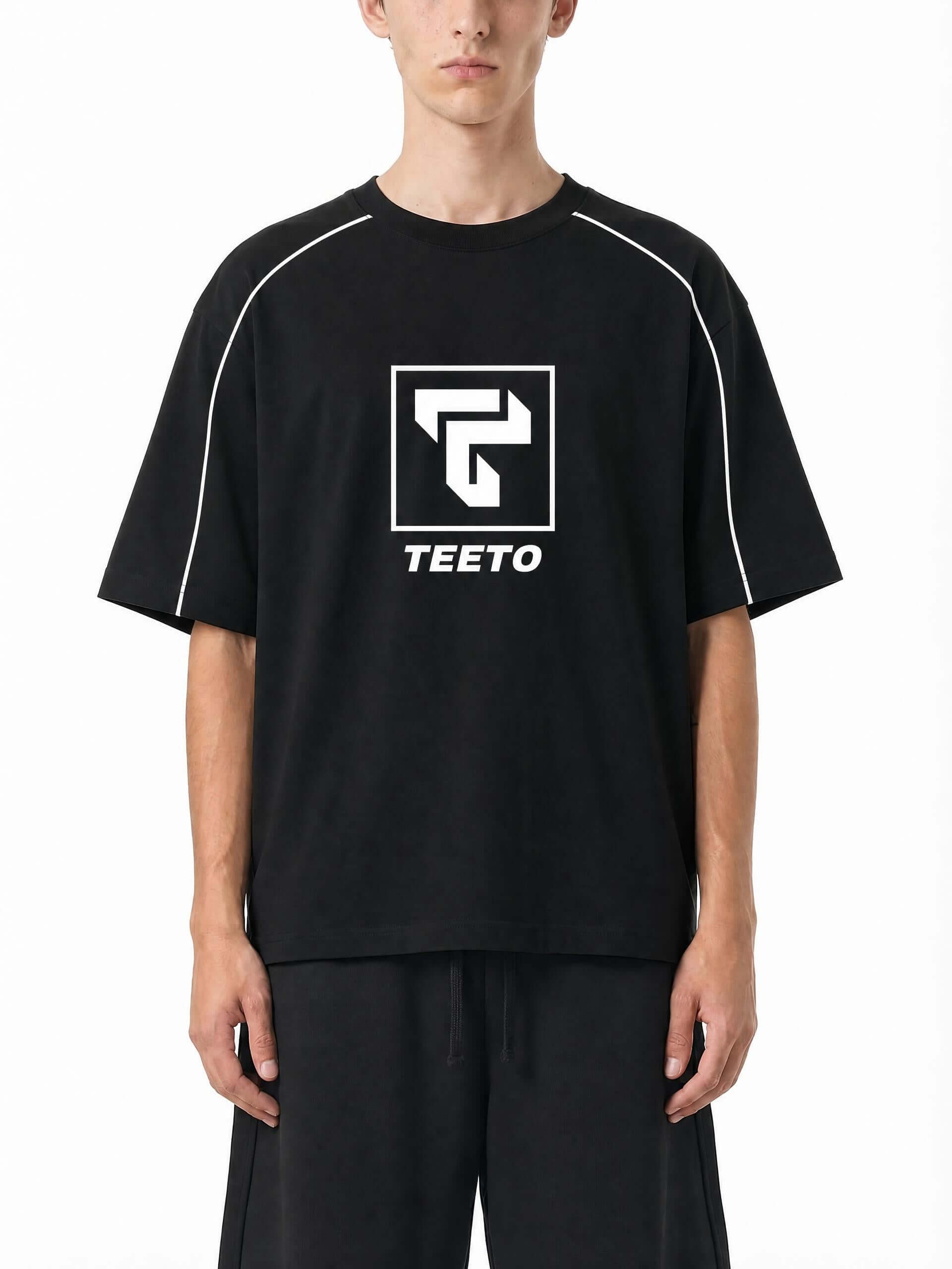 Teeto Heavyweight Boxy Piping T-Shirt in Black worn by a model, front view.