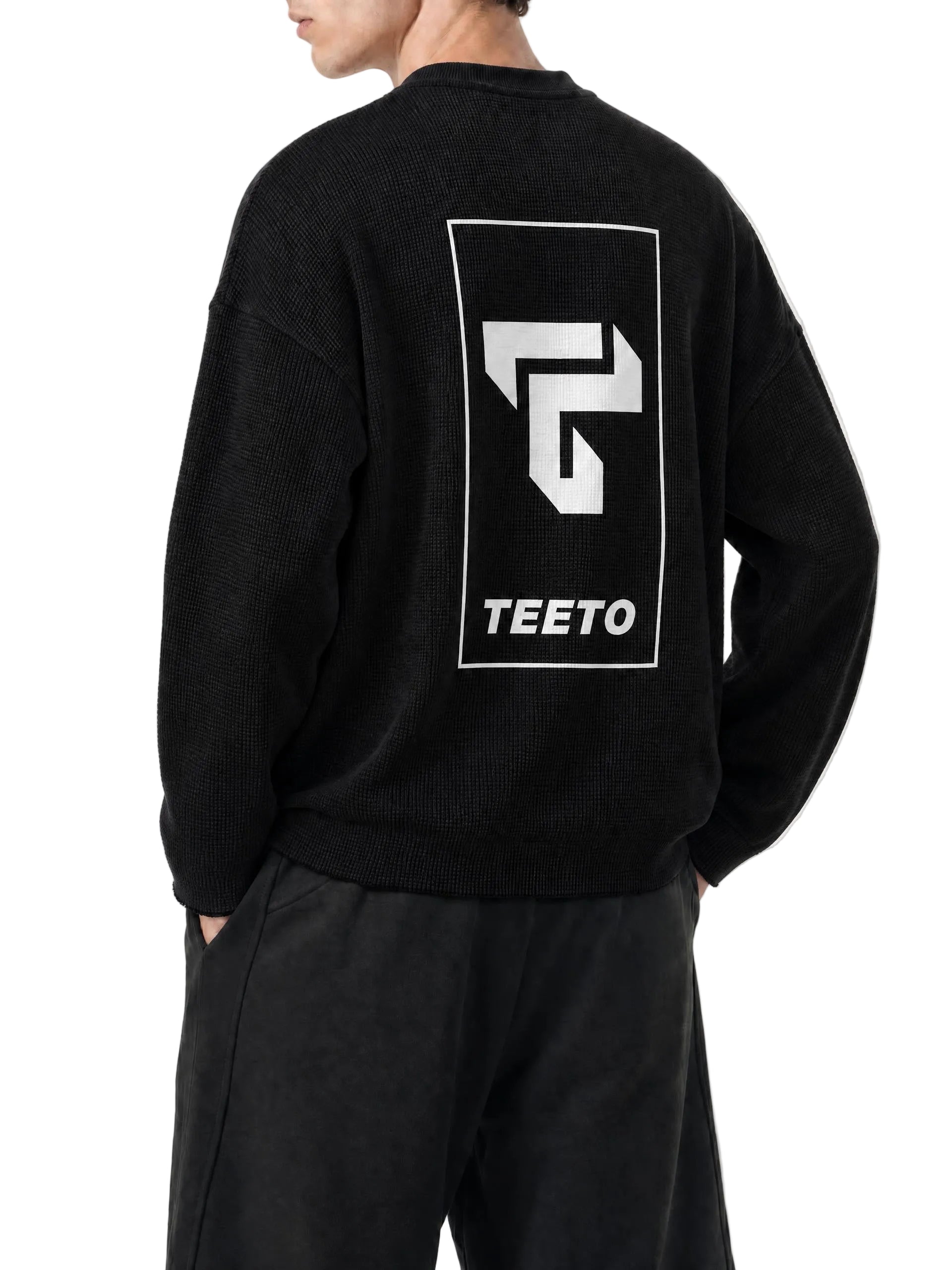 Teeto Waffle Raw Edge T-Shirt in Black worn by a model, back view with TEETO back logo.